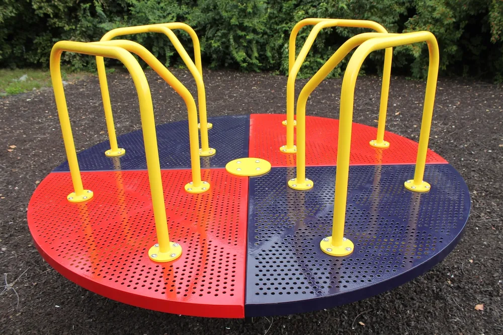 Outdoor rotary merry go round with safety railing